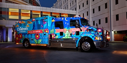 Semi wrapped in a 3M truck and trailer graphic wrap that has a man with a mustache between two American flags.
