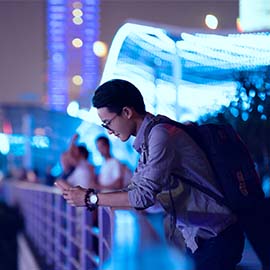 Tourist using his phone in a crowded area.