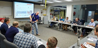 Group of workers in a classroom learning from fall protection instructor
