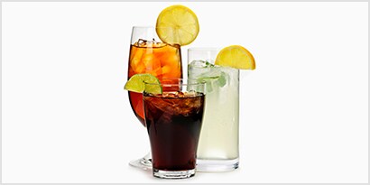 three cold beverage drinks in glasses with ice
