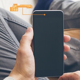 Person holding a smartphone where 3M's FPC bonding for consumer electronics can be used.