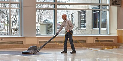 facility manager buffing a facility floor with 3M products
