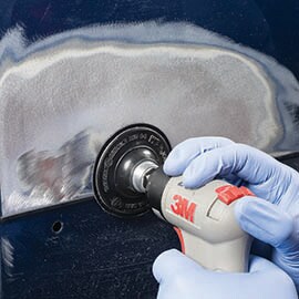 using a Scotch-Brite Clean and Strip abrasive disc on automobile