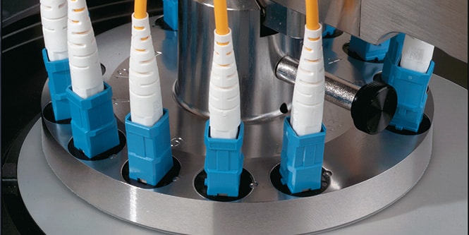 Close-up of a polishing machine using 3M™ Films for precision finishing, featuring multiple connectors and advanced technology