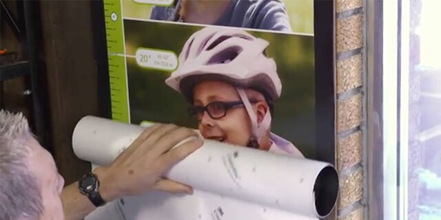 Person holding a 3M film adhesion test instrument
