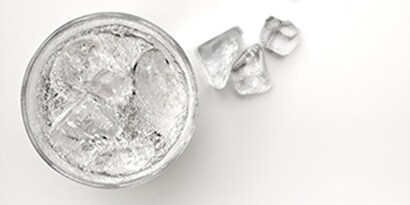 glass with ice cubes and water in it
