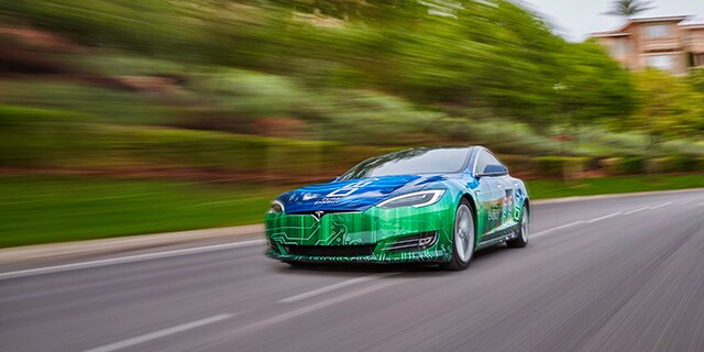 Sports car speeding down a highway wrapped in the versatile 3M 480mC graphics film.
