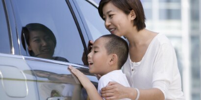 car sales associate and two customers in a dealership
