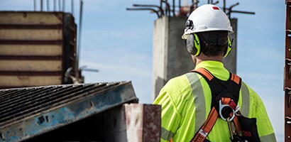 Worker wearing 3M earmuffs and other PPE

