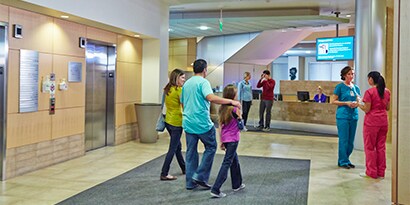 happy family walking through health care facility
